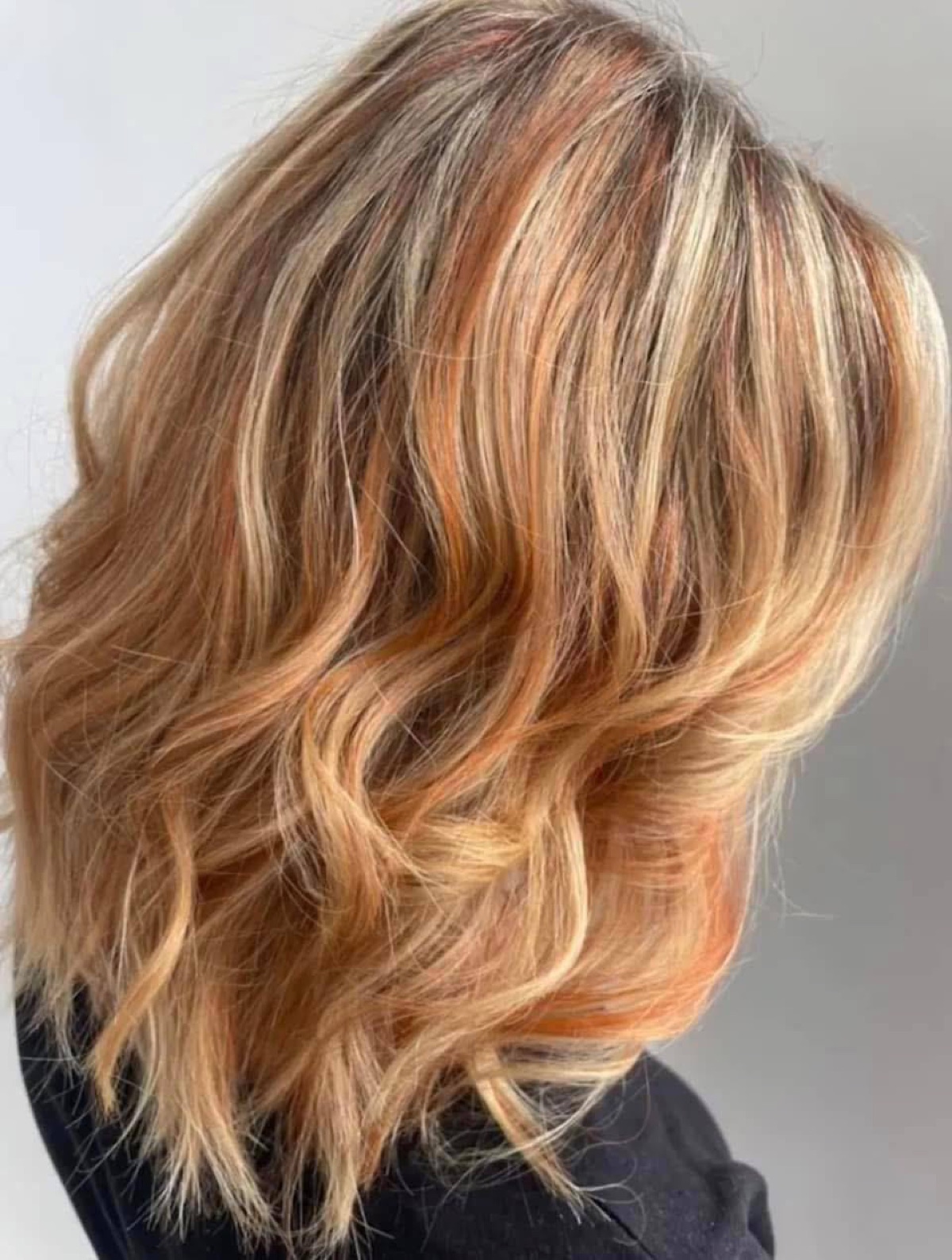 Warm copper blonde colour work by Storm at The Studio
